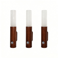 Three wooden wall sconces with white cylindrical shades on a white background