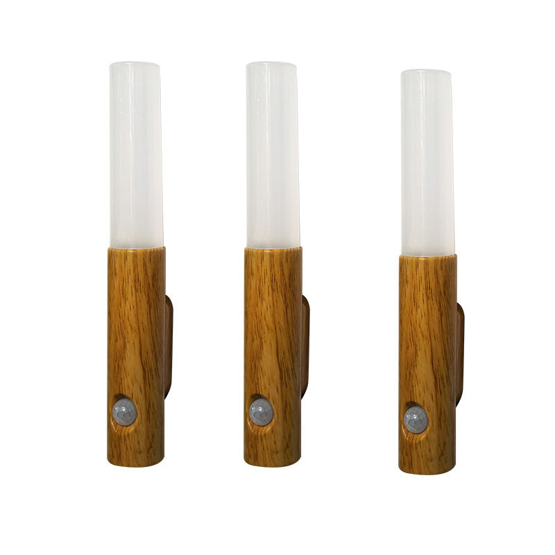 Three wooden wall sconces with glass shades on a white background