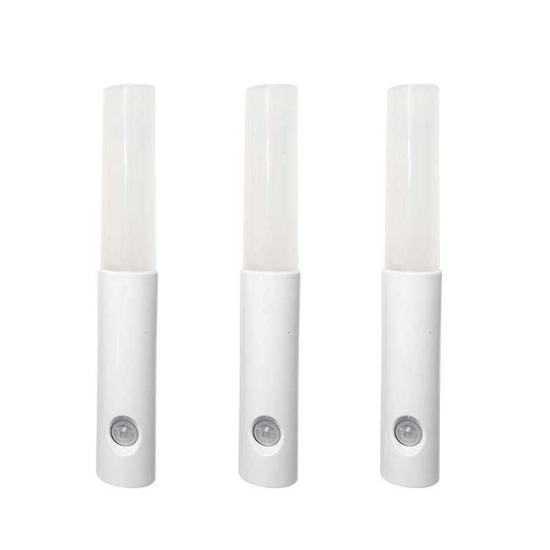 Three white motion sensor lights on a white background