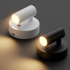 Two wall-mounted lights, one white and one black, on a dark background.