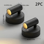 Two black spotlight fixtures with dimensions and a measurement label on a gray background