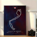 Poster of Circuit de Monaco track layout on a wall with a camera below.