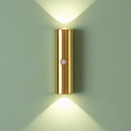 Gold wall-mounted light fixture on a gray wall