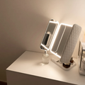Makeup mirror with light on a white surface