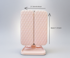 Pink quilted mirror with dimensions indicated on a gray background
