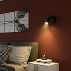 Modern bedroom with a bed, nightstand, wall art, and wall lamp.