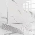 Stack of white ceramic tiles with a marble pattern on a light gray background