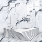 Stack of white books with marble cover design on a blurred natural background