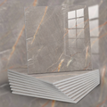 Stack of gray marble tiles with gold veining on a blurred background