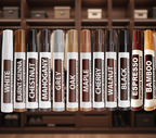 Row of furniture repair markers with various colors against a blurred wooden background